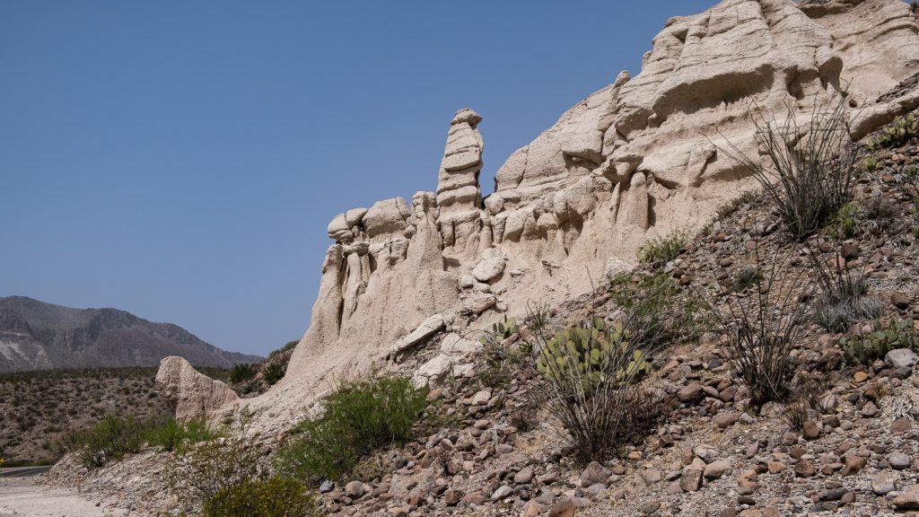 Rock outcrop with uniquely formed rock towers and cacti in the forefront