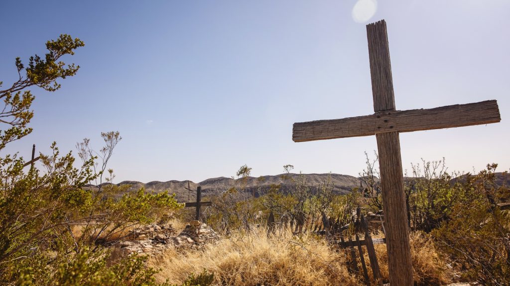 Historic desert graveyard with cross