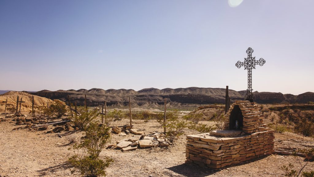 Historic desert graveyard with cross