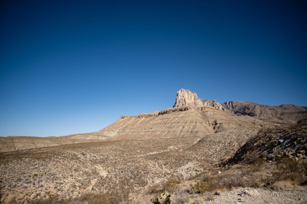Distance view of mountain outcrop and clear blue sky