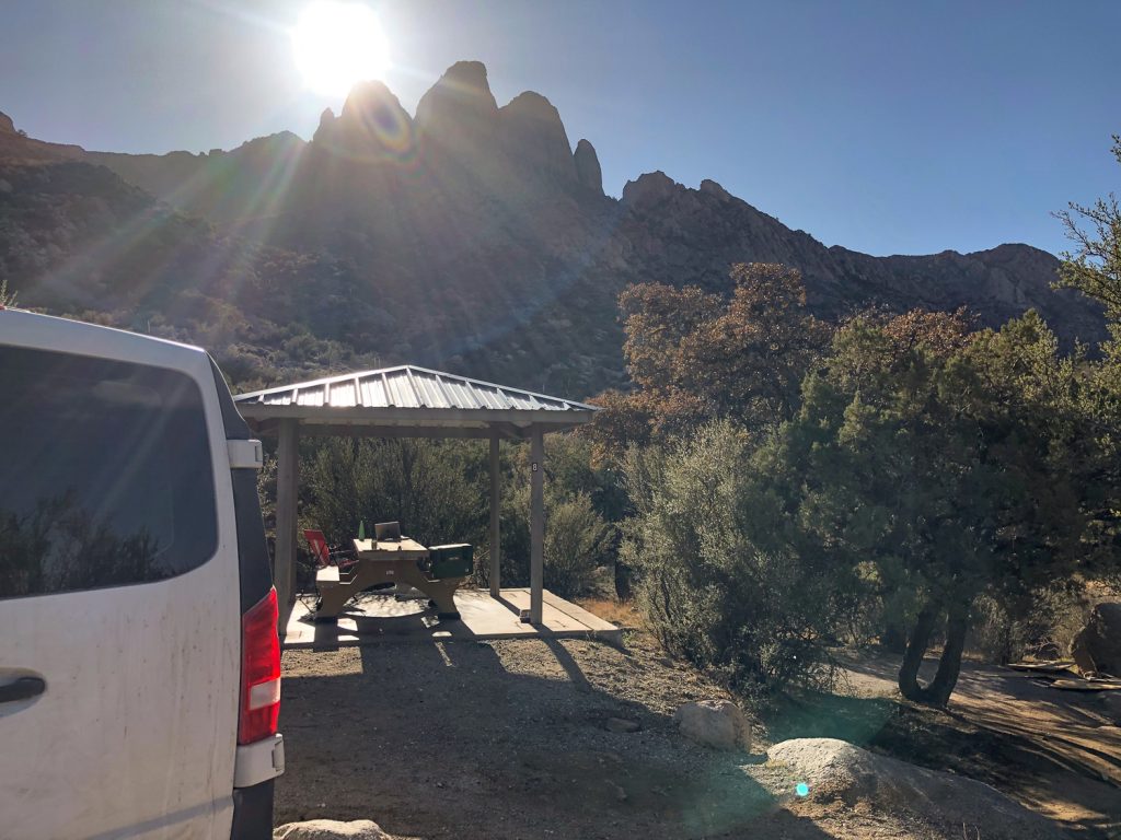 Jagged mountain rising above the van and picnic shelter