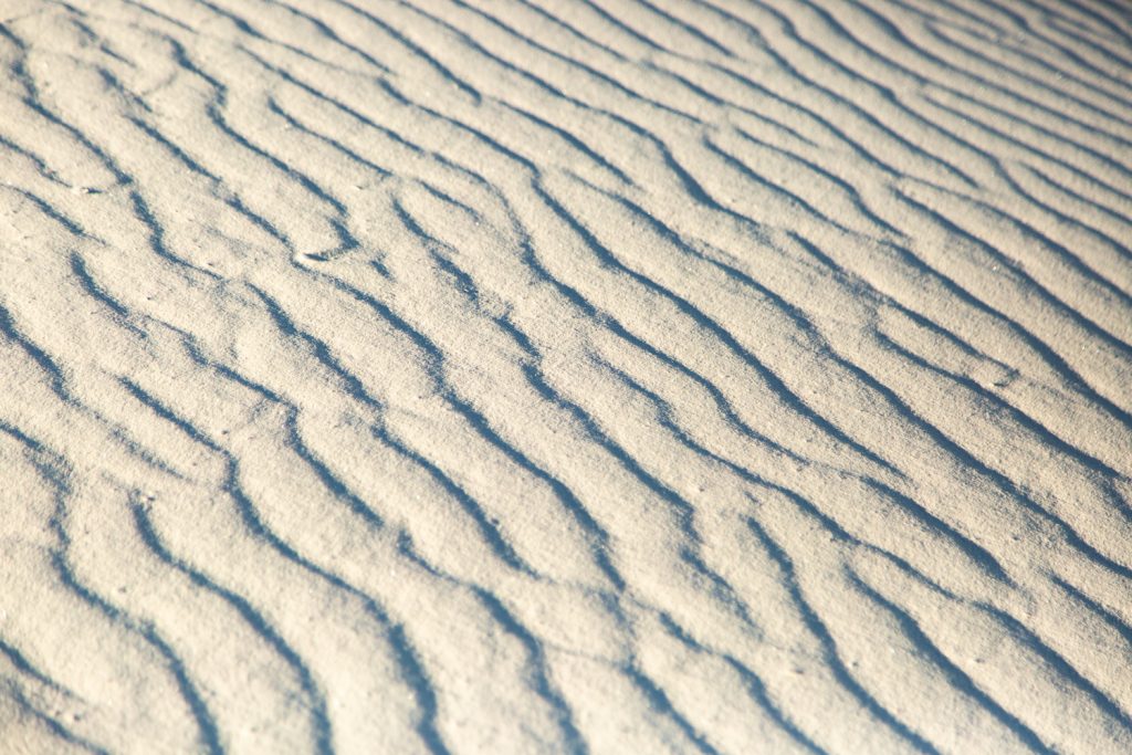 Closeup of the white sand with ripples from the wind